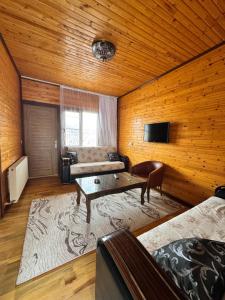 a living room with a couch and a table at Ertunç Turizm in Kahramanmaraş