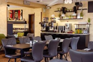 a restaurant with tables and chairs and a counter at INTER BUSINESS Bucharest in Bucharest