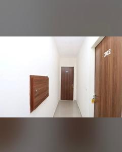 an empty hallway with a door and a corridor at FB Hotel in Kharar