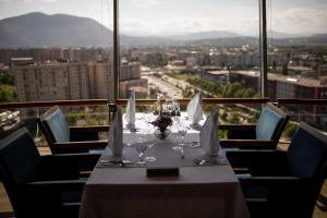 a table in a restaurant with a view of a city at Radon Plaza in Sarajevo