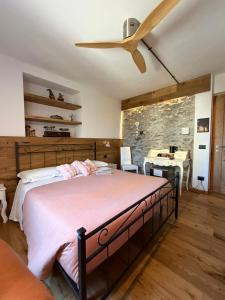 a bedroom with a large bed and a ceiling fan at Il posto al sole in Teglio +82 photos