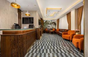 a hotel lobby with a bar and orange chairs at Taksim Peradise Hotel in Istanbul