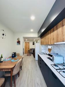 a kitchen with a table and a counter top at Kitesa's apartment with two bedrooms in Mtskheta