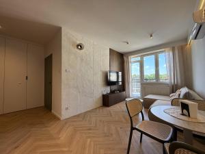 a living room with a couch and a table at Kresowy View Apartment in Biłgoraj