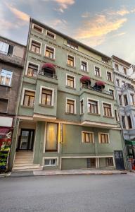a large green building with windows on a street at Taksim Peradise Hotel in Istanbul