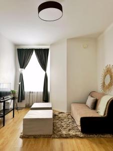 a living room with a couch and a table at 1BR Demure Design & Urban Living in Kamppi in Helsinki