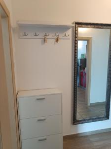 a dresser in a room with a mirror at Apartment Domagoj, Novalja,with 3 air conditioning units in Novalja