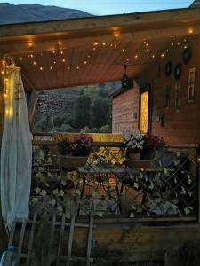 a patio with a table and potted plants and lights at Kazbegi Mountain Cottage MTA-Shi in Kazbegi +54 photos