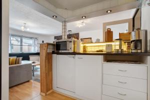 a kitchen with a counter top with a microwave at Ferienwohnung Hundefreundlich 70 qm in Barth +22 photos