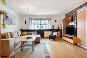 a living room with a couch and a table at Ferienwohnung Hundefreundlich 70 qm in Barth
