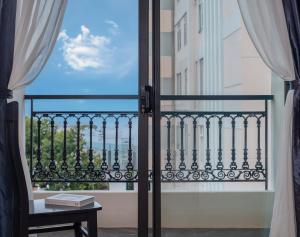 a room with a view of a balcony with a window at Jolia Nha Trang Hotel in Nha Trang