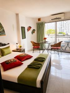 a bedroom with a large bed and a dining room at View Talay 1B Holidays in Pattaya South