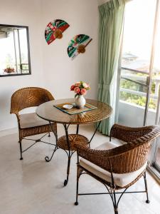 a table and chairs with a vase of flowers on it at View Talay 1B Holidays in Pattaya South