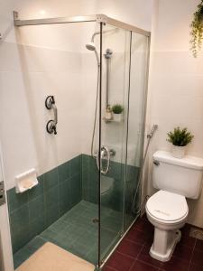 a bathroom with a glass shower with a toilet at View Talay 1B Holidays in Pattaya South +12 photos