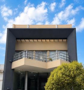 a building with a balcony on the side of it at Paramont Rosario 4 in Rosario de la Frontera