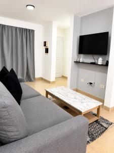 a living room with a couch and a coffee table at Paramont Rosario 4 in Rosario de la Frontera