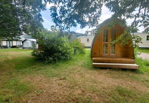 a small wooden house sitting in the grass at Camp Diekirch - Camping Pod in Gilsdorf