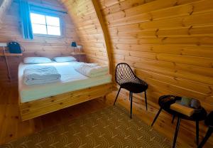 a bedroom with a bed in a log cabin at Camp Diekirch - Camping Pod in Gilsdorf