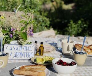 a table with plates of food and bread on it at El Carpintero in Trevélez
