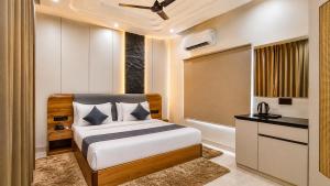 a bedroom with a large bed and a window at The JJ Corbett Bliss, Sitabani A River Access Wildlife Resort in Amgarhi