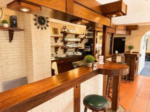 a bar with a wooden counter in a restaurant at Hotel Panorama Nickenich in Nickenich
