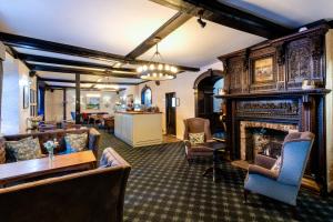 a living room with a fireplace and a table and chairs at Best Western Red Lion Hotel in Salisbury