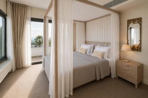 a bedroom with a bed and a large window at Droushia Heights Hotel in Drousha +43 photos