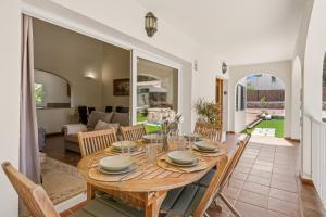 a dining room and living room with a table and chairs at SolParc 589 by 3VILLAS in Son Parc