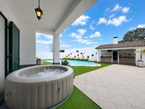 an outdoor hot tub in the yard of a house at Casa Vereda Ponta Delgada, S Miguel in Ponta Delgada