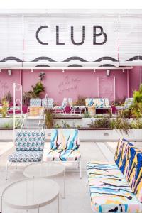 a store with chairs and tables and a pink wall at The Kuala Lumpur Journal Hotel in Kuala Lumpur
