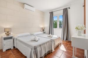 a white bedroom with a bed and a window at SolParc 589 by 3VILLAS in Son Parc +45 photos