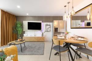 a living room and dining room with a table and chairs at Infinity Summer in San Miguel de Abona