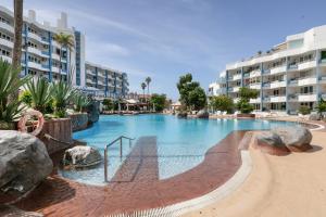 a large swimming pool in a resort with buildings at Infinity Summer in San Miguel de Abona
