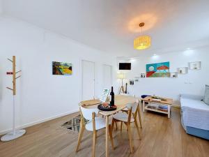 a living room with a table and chairs and a couch at Casa Vereda Ponta Delgada, S Miguel in Ponta Delgada