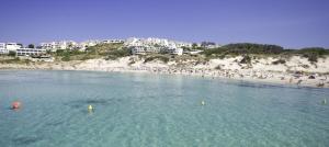 a beach with a bunch of people in the water at SolParc 589 by 3VILLAS in Son Parc