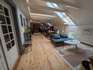 a living room with a couch and a table at Sigurd's Loft in Vossevangen