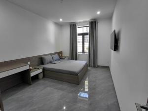 a bedroom with a bed and a television in it at ZENITH STAY by Lan's in Danang