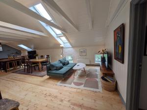 a living room with a couch and a table at Sigurd's Loft in Vossevangen