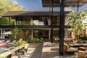 an exterior view of a house with a swimming pool at Hotel Together Bali in Uluwatu