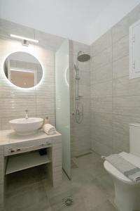a white bathroom with a sink and a shower at Villa Elva in Ammoudia +101 photos