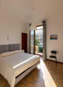 a bedroom with a large bed and a large window at Albergo NARDINI in Le Grazie