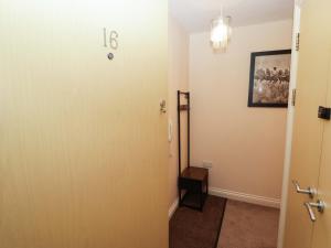 a hallway with a door with the number on it at Twyni Bach in Burry Port +18 photos