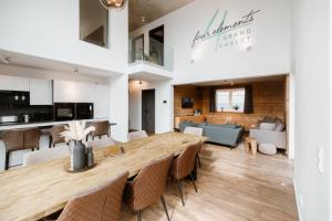 a dining room and living room with a table and chairs at FourElements Grand Chalet in Blankenburg