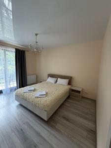 a bedroom with a bed and a large window at ''Панорама Карпат'' Апартаменти в чудовому місті Яремче in Yaremche