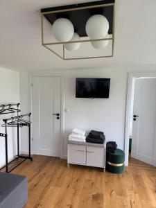 ein Wohnzimmer mit weißen Wänden und Holzböden in der Unterkunft Tiny House ROA in Recea
