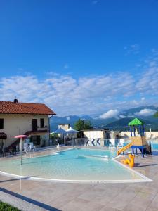 a swimming pool with a slide and a playground at Casa Ines in Brezzo