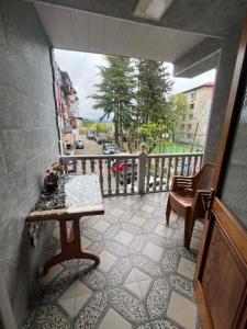 a balcony with a table and chairs and a street at there is no a name in Itʼkhvisi