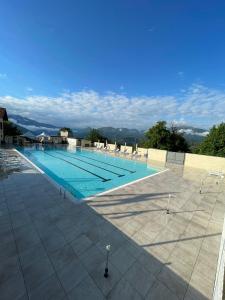 an empty swimming pool with chairs and a blue at Casa Ines in Brezzo +16 photos