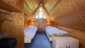 a room with two beds in a wooden cabin at Casa Ines in Brezzo