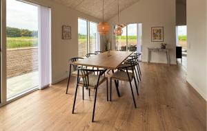 a dining room with a wooden table and chairs at 4 Bedroom Cozy Home In Haderslev in Haderslev